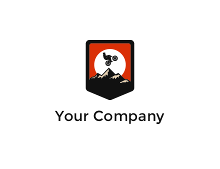 jumping bike and mountain emblem